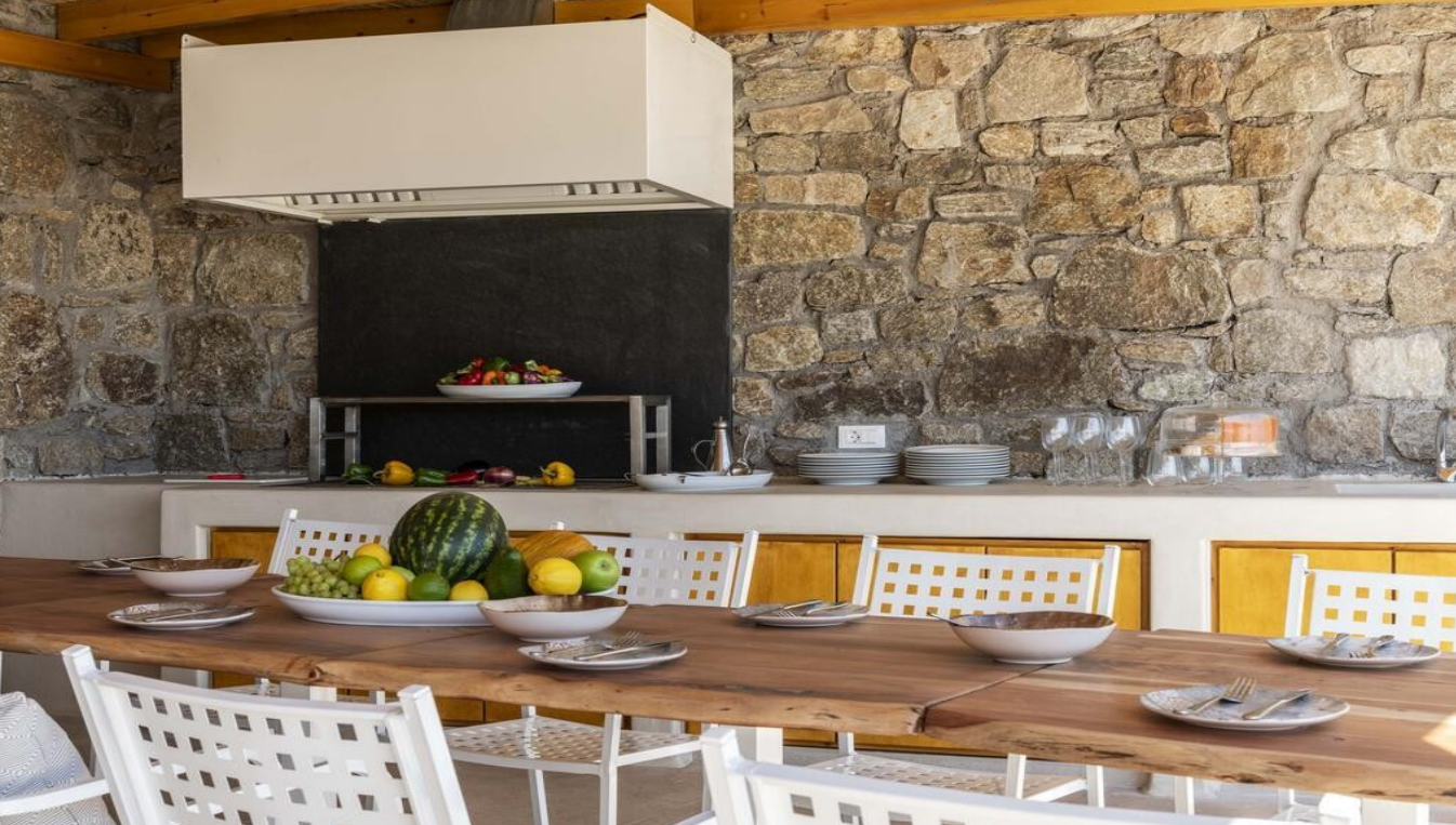 luxury-villa-outdoor-kitchen-with-wooden-table-and-fruits-ibiza