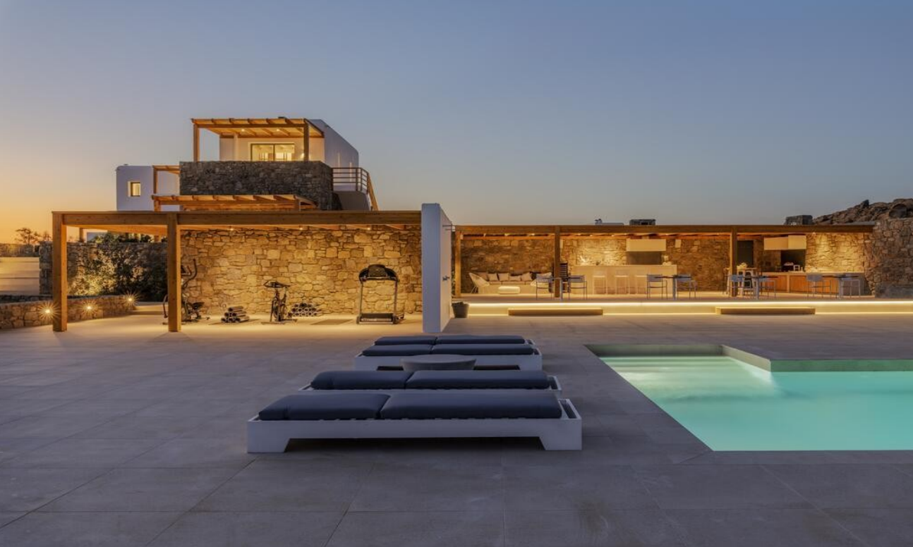 luxury-villa-pool-outdoor-gym-and-kitchen-at-dusk-ibiza