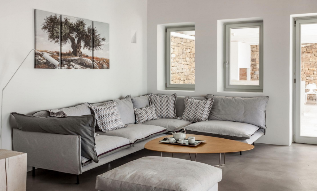 modern-living-room-corner-with-gray-sectional-sofa-and-olive-tree-wall-art