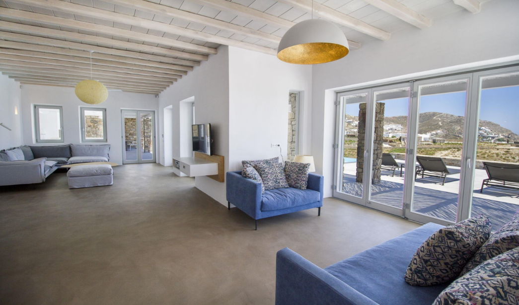 modern-living-room-with-blue-sofa-and-open-view-to-garden