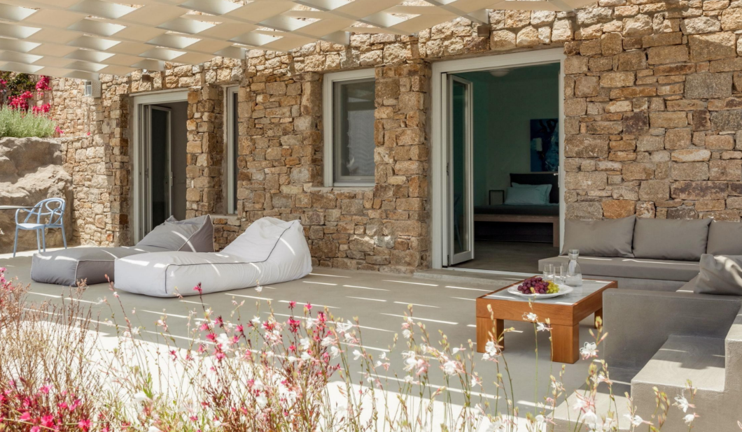 stone-wall-patio-furniture-relaxing-seating-area-beautiful-flower-plants