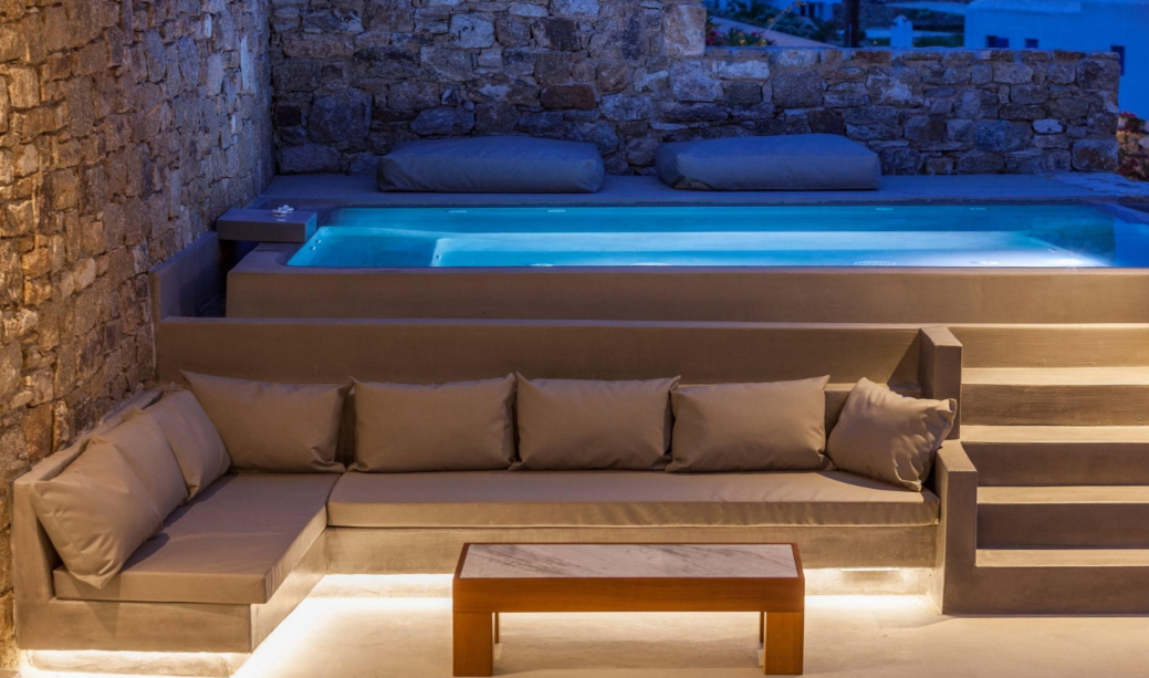 luxurious-outdoor-seating-poolside-stone-wall-relaxing-area
